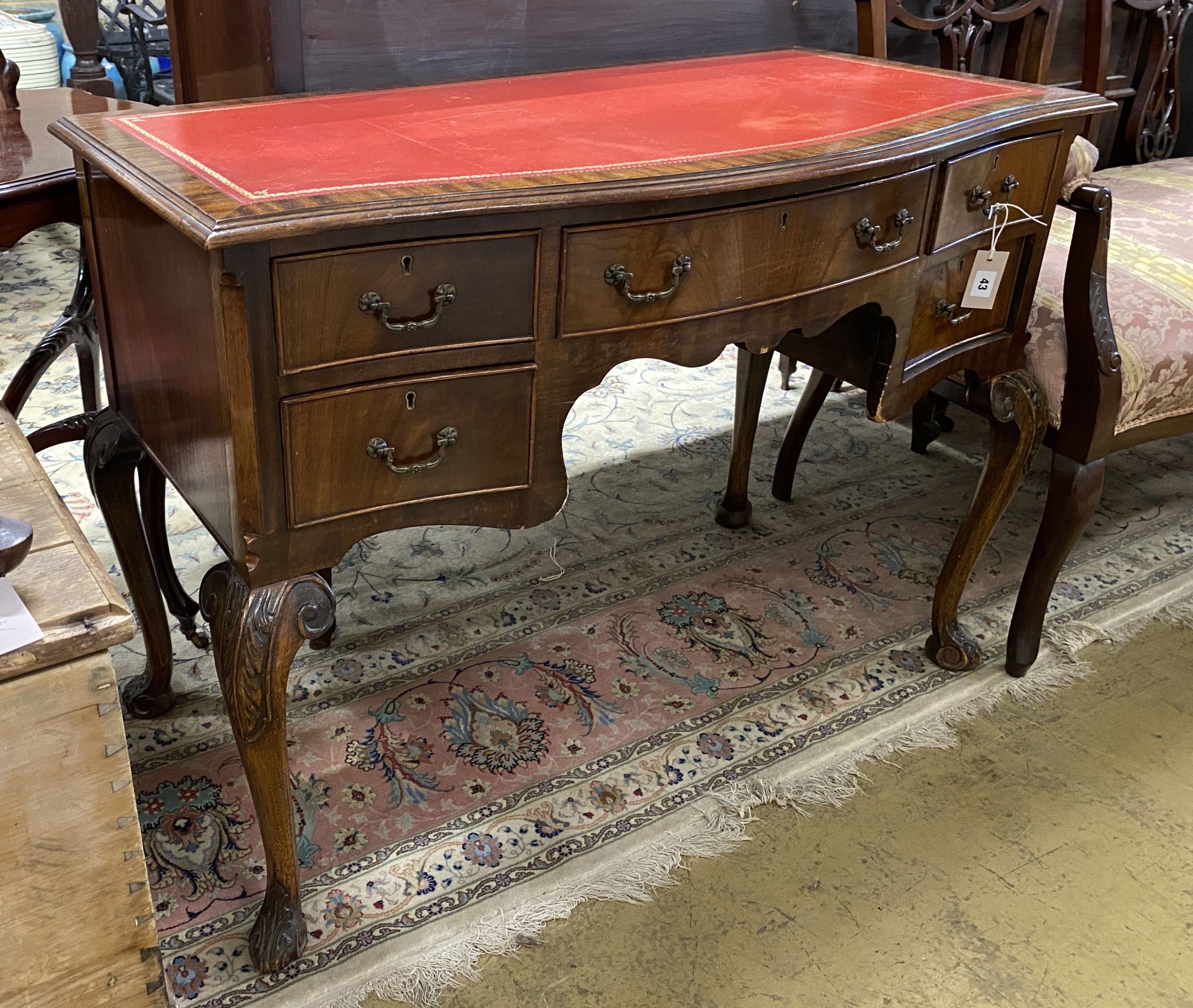 A reproduction George III style serpentine mahogany kneehole writing table, width 107cm, depth 55cm, height 78cm